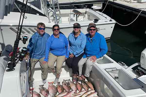 four people sitting on a boat