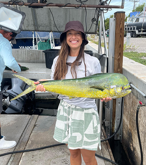 Woman holding a mahi mahi after Key West fishing charter