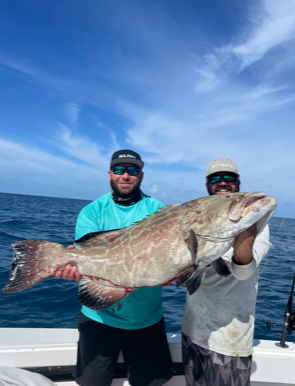 two men holding a fish
