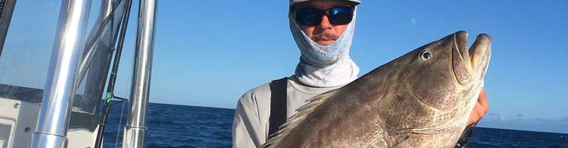 Key West fishing charter with man holding a grouper